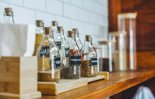 a row of bottles filled with spices on a counter at @Casa.Mauii - Ilha do Guajiru Luxurious House in Itarema