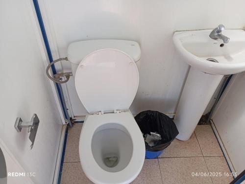 a bathroom with a toilet and a sink at Camper K Not for driving Playa las Vistas in Adeje