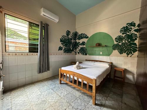 a bedroom with a bed in a room at Hostal Tia Reyna in El Zonte