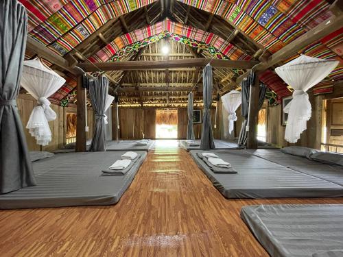 a room with four beds in a building at Puluong Mist Valley Home in Pu Luong