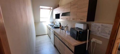a kitchen with a counter top with a microwave at Holiday home in Keszthely - Balaton 54377 in Keszthely