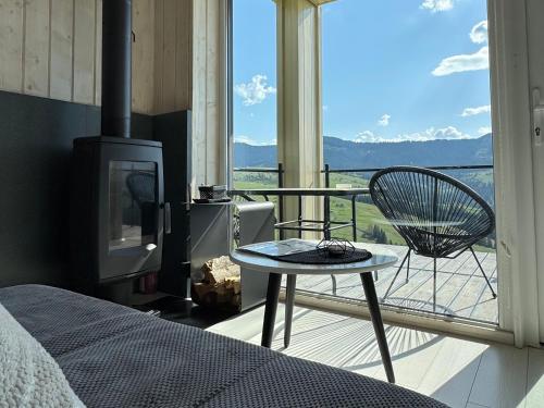 a room with a bed and a chair on a balcony at Magurka Space in Verkhovyna