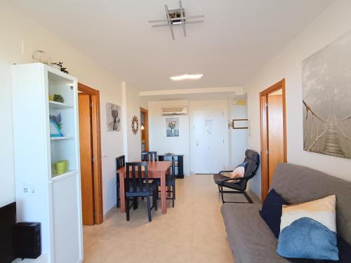 a living room with a couch and a table at AyF VISTAS A LA PLAYA MORRO DE GOS Y WIFI in Oropesa del Mar