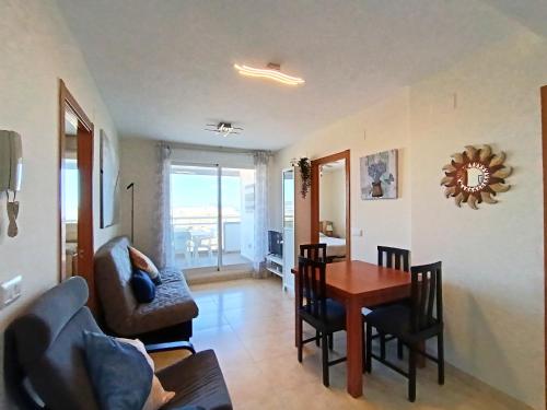 a living room with a table and a dining room at AyF VISTAS A LA PLAYA MORRO DE GOS Y WIFI in Oropesa del Mar