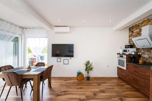 a kitchen and dining room with a table and chairs at MY DALMATIA - Apartment Nikita with private pool in Zaboric