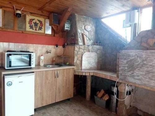 a small kitchen with a sink and a microwave at Heaven in Draginovo