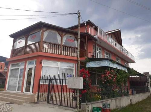a red building with a balcony on top of it at Heaven in Draginovo