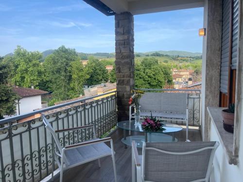a balcony with two chairs and a table with a view at Suite Sant'Anna in Greve in Chianti
