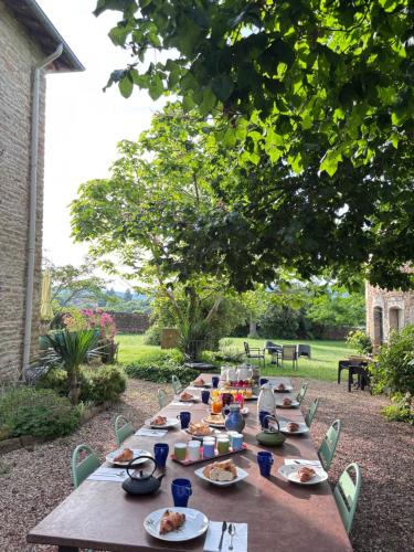 a long wooden table with plates of food on it at domaine du vernay in Mazille