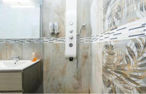 a bathroom with a shower with a sink and a mirror at Yaki Domo in Cagliari