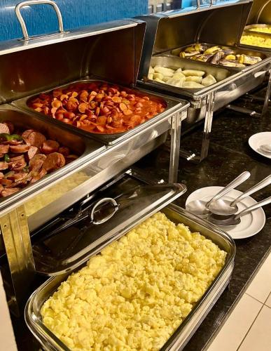 a buffet line with many different types of food at Pousada Caribe Brasileiro in Maragogi