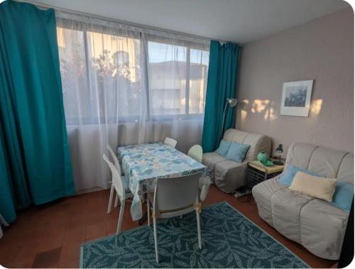 un salon avec une table et un canapé dans l'établissement Appartement six personnes proche de la mer, à Six-Fours-les-Plages