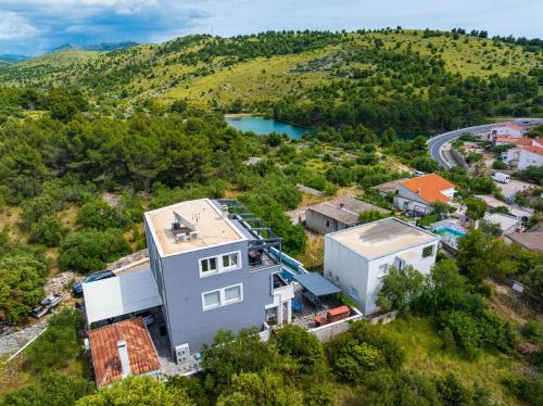 an aerial view of a house with a lake at MY DALMATIA - Apartment Nikita with private pool in Zaboric