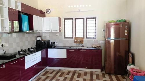 a kitchen with a refrigerator and a sink at Jewel Homes Thattekad For birding and families - An ISO9001 ISO14001 ISO22000 Certified in Thattakād