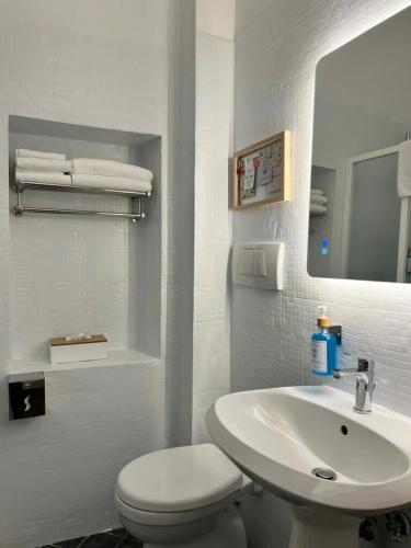 a white bathroom with a toilet and a sink at Lerici Charme in Lerici