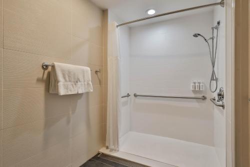 a shower with a glass door in a bathroom at The Penn Stroud, Stroudsburg - Poconos, an Ascend Collection Hotel in Stroudsburg
