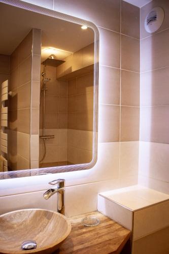 une salle de bain avec un lavabo et un miroir dans l'établissement ADB - parking, balcon et centre ville, à Albertville