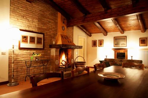 a living room with a table and a fireplace at Akasamia B&B - La Dimora in Itri