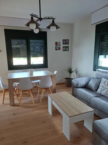 a living room with a table and a couch at A casa da Piruleta in Bueu