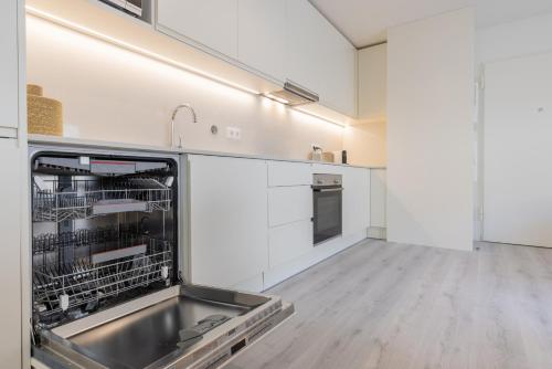 a kitchen with a sink and a dishwasher at Peniche Hideout in Peniche