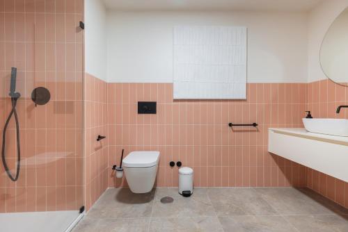 a bathroom with a toilet and a sink at Peniche Hideout in Peniche