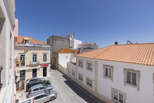 a view of cars parked in a parking lot between buildings at Peniche Hideout in Peniche
