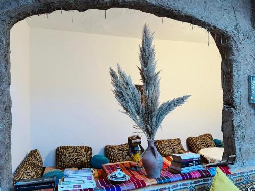 a living room with a couch and a table with books at Tamri Dar Taous in Tamri
