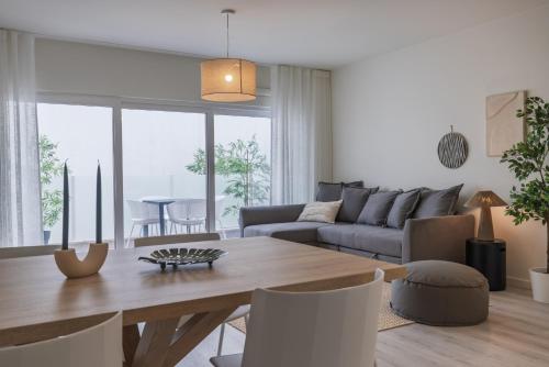 a living room with a table and a couch at Peniche Hideout in Peniche