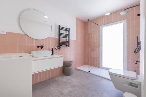 a bathroom with a sink and a toilet and a mirror at Peniche Hideout in Peniche