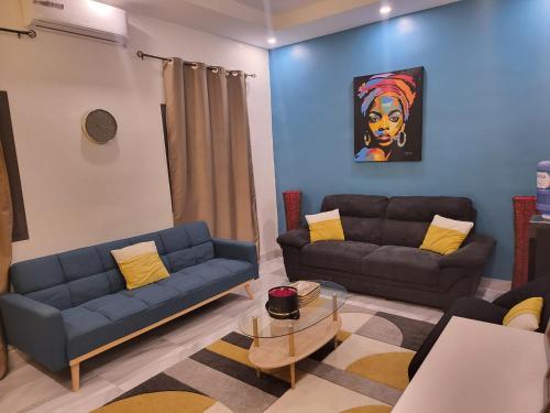 a living room with two couches and a painting at Belle VILLA Apt Mamelles, Monument de la renaissance arrondissement ALMADIES in Ouakam