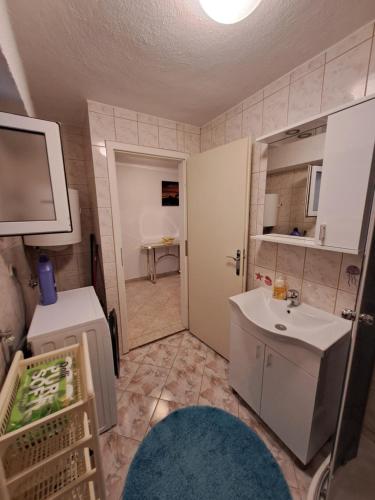 a small bathroom with a sink and a mirror at Apartment Boras in Senj