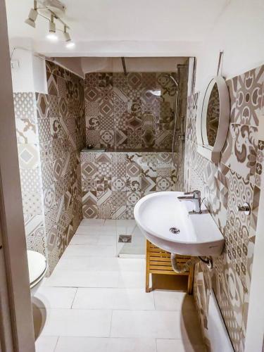 a bathroom with a sink and a toilet at Al centro di Gaeta - CasAurora PT in Gaeta