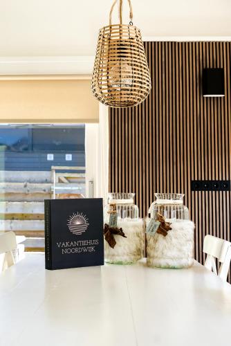 a white table with chairs and a chandelier at -Duna Lago- nabij het meer, restaurants en Keukenhof in Noordwijkerhout