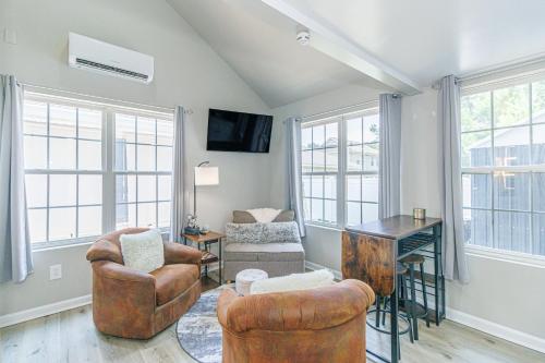 a living room with chairs and a table and windows at Cozy Tiny Home for 2! Short drive to the Beach! in Myrtle Beach
