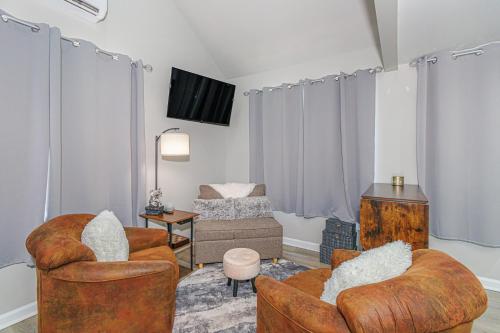 a living room with two chairs and a tv at Cozy Tiny Home for 2! Short drive to the Beach! in Myrtle Beach