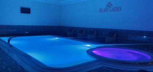 a bath tub with a purple toilet in a room at Milano Garden Plaza Samarkand in Samarkand