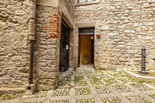 an old stone building with a yellow door at Santa Teresa in Erice