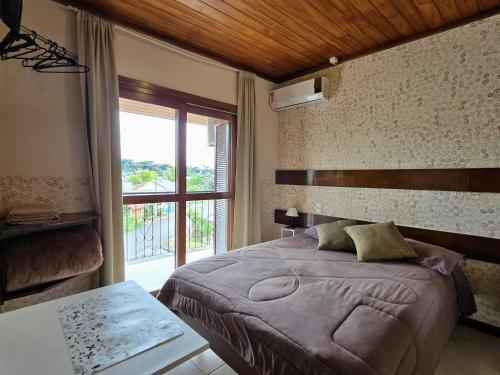 Postel nebo postele na pokoji v ubytování Residencial Borges Canela
