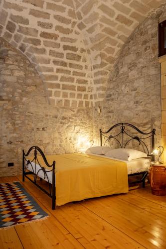 a bedroom with a bed in a brick wall at Santa Teresa in Erice