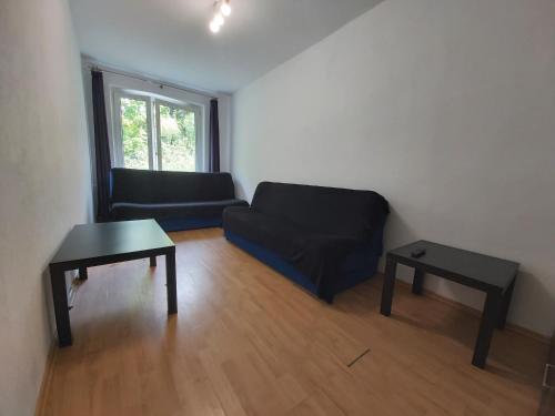 a living room with a couch and a table at 2050 Zwycięstwa 23 - Tanie Pokoje - samodzielne zameldowanie - self check in in Poznań