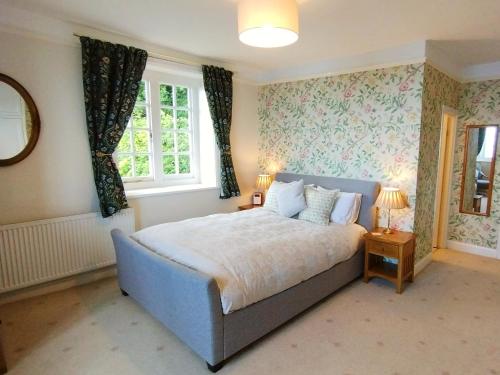 a bedroom with a bed and a window at Chough's Nest Hotel in Lynton
