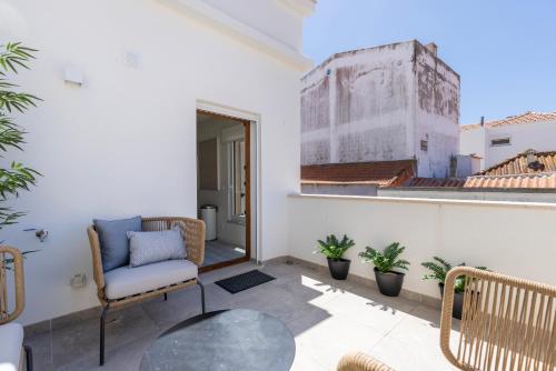 a balcony with a chair and a glass table at Peniche Hideout in Peniche