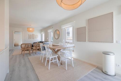 a dining room and living room with a table and chairs at Peniche Hideout in Peniche