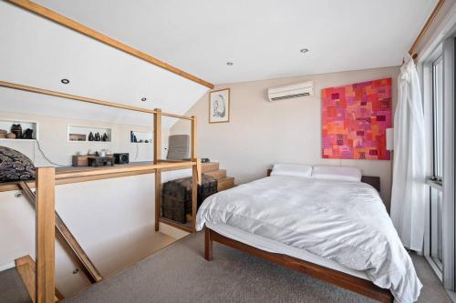 una camera da letto con un letto, una scrivania e una finestra di Fremantle Character Cottage a Fremantle