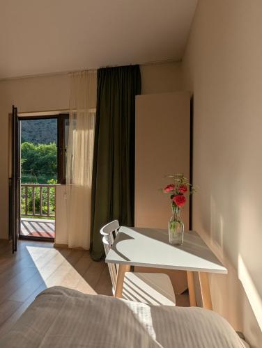 a bedroom with a table with a vase of flowers on it at Bee House in Kilda