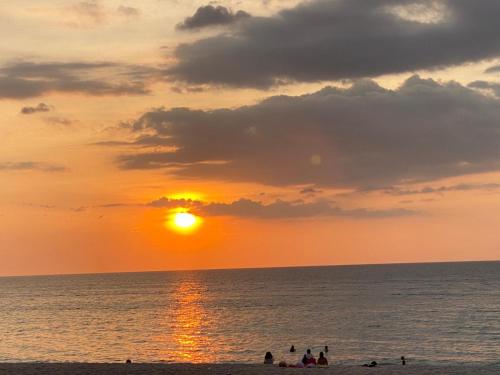 a group of people on the beach at sunset at Playa Jandia Fuerteventura in Morro del Jable
