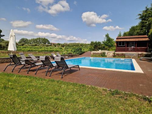 a group of chairs sitting next to a swimming pool at Casa de Sao Miguel Douro in Armamar