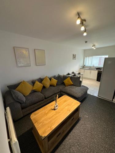 a living room with a couch and a coffee table at Orchard Court Spacious 2 bedroom apartment in Wednesbury