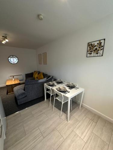 a living room with a couch and a table at Orchard Court Spacious 2 bedroom apartment in Wednesbury