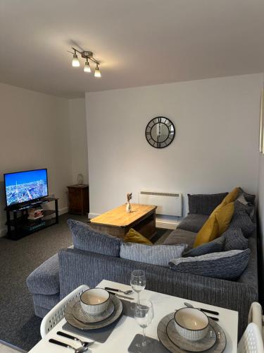 a living room with a couch and a table at Orchard Court Spacious 2 bedroom apartment in Wednesbury